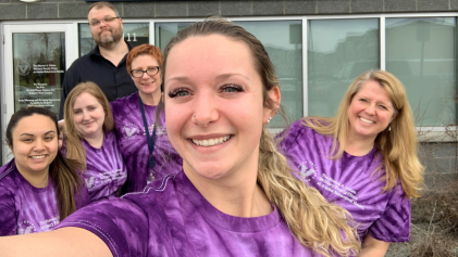 group of people wearing purple shirts