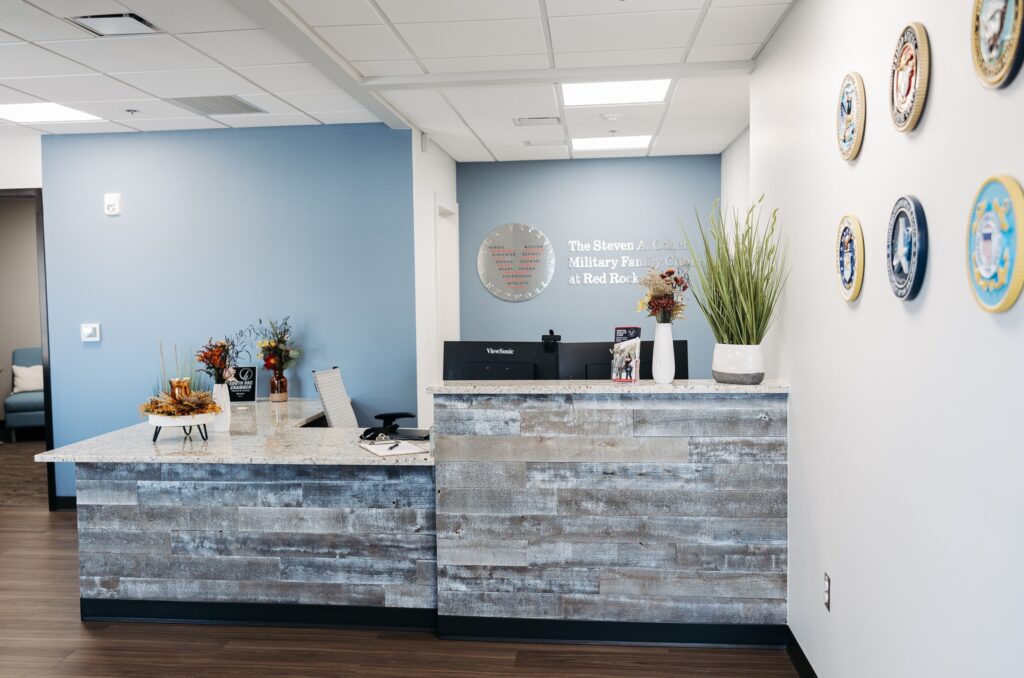 Steven A. Cohen Military Family Clinic  welcoming reception area featuring seals for every branch of the US Military